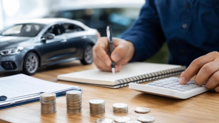 Person planning a budget for a vehicle upgrade with calculator and car model